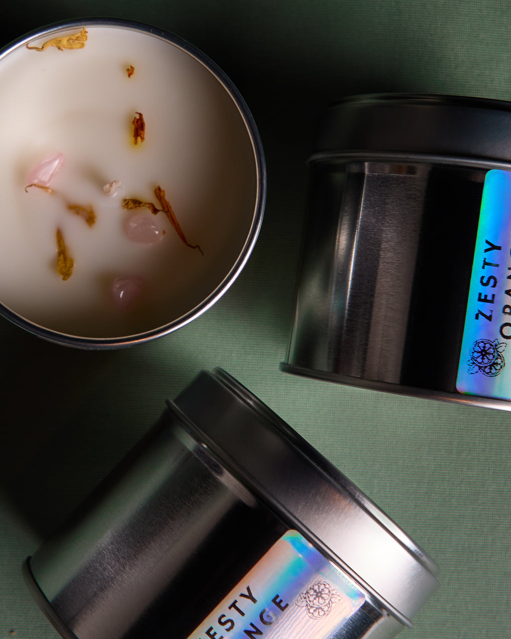 A collection of  Luxury hand poured soy wax candle in a silver tin jar with natural soy wax colour and dried lavender petals on top, finished with holographic silver label