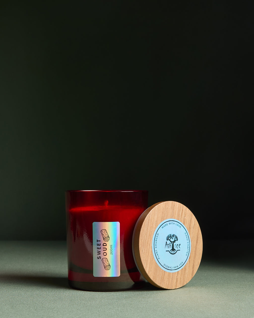 Red wax candle in red glass jar with glossy finish. Luxury packaged candles.