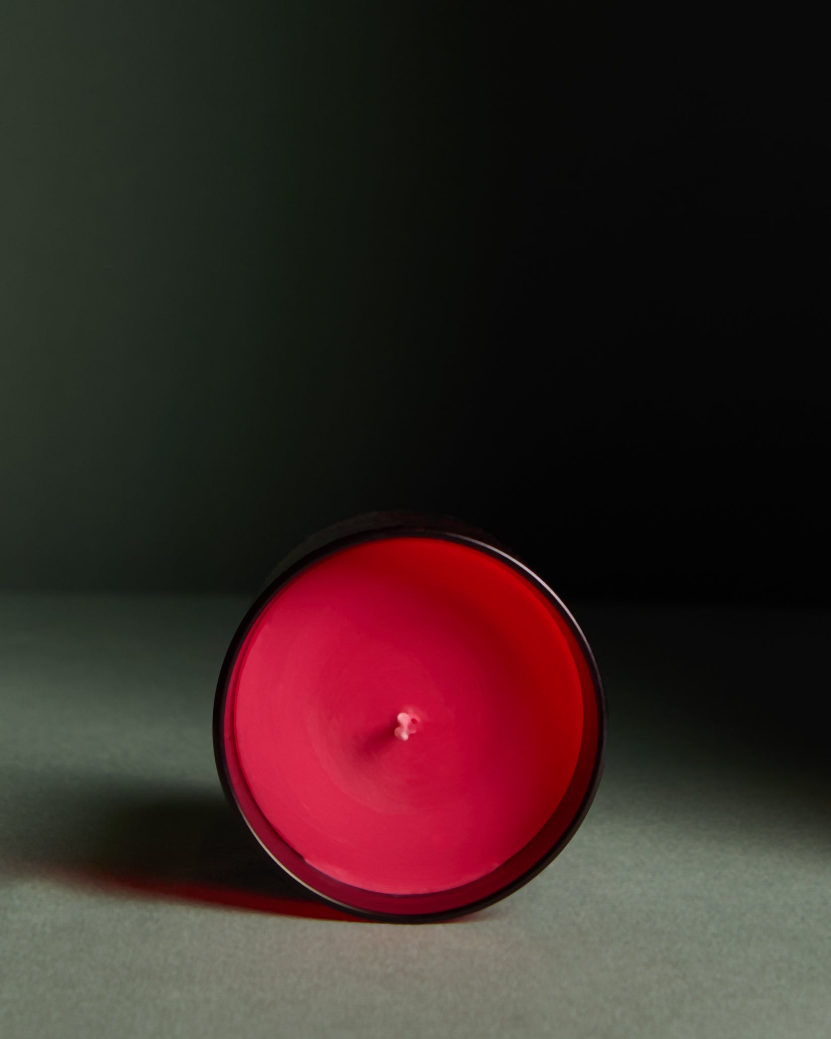 Red candle on a dark background